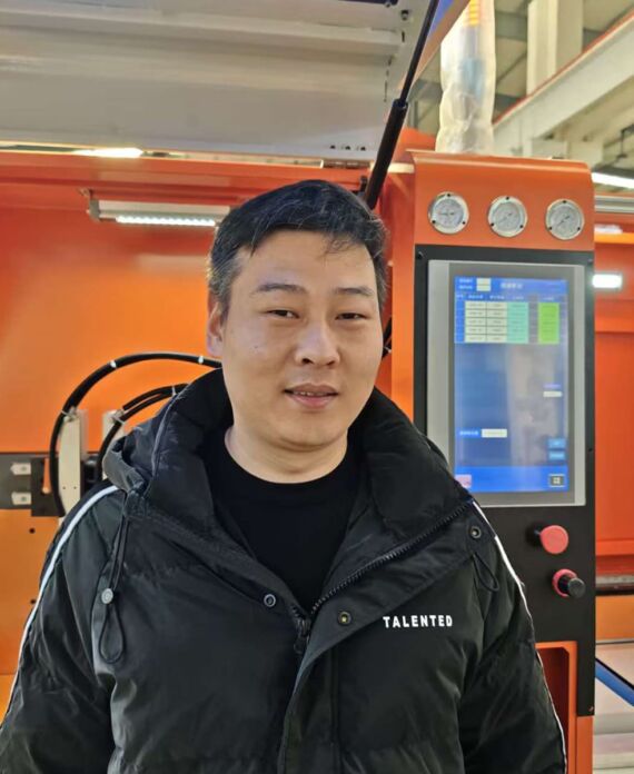Mu Nan (Production Manager) beside Jiurun aluminum cutting machine control panel