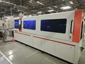 JR-550CNC Fully Automatic Corner Bending Machine in industrial production site (side view with enclosed operation chamber)